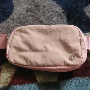 Lululemon belt bag in light coral. Extended strap version.